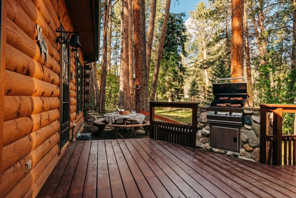 Relax on the wooden porch surrounded by towering pines.