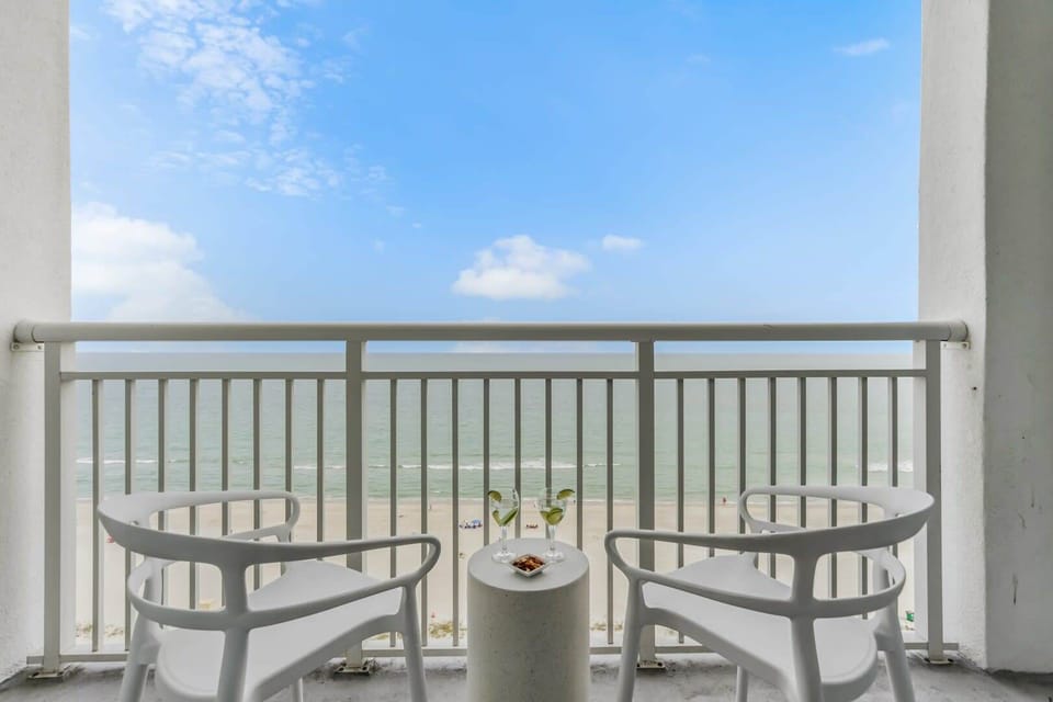 Sip your favorite drink while soaking in breathtaking ocean views from this private balcony. With cozy seating and serene beach vibes, it's the perfect spot to relax and enjoy the coastal breeze.