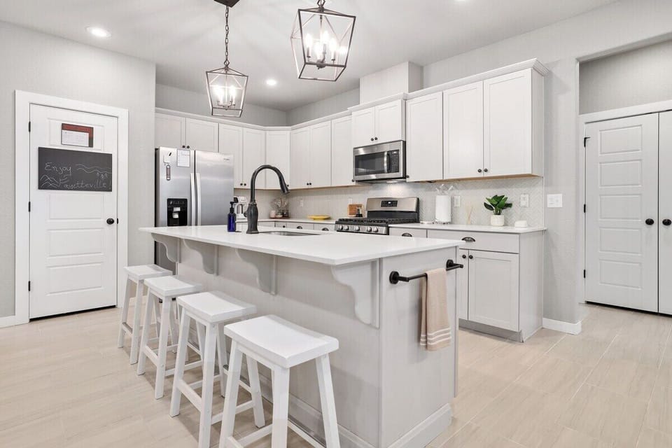 In the center of the kitchen, you'll see a large island with barstool seating.
