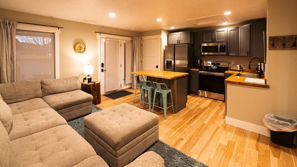 Living room and kitchen with in-unit washer and dryer - everything you need for an extended stay in Cody!