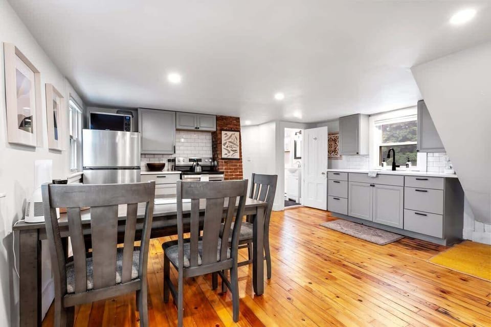 The dining area is conveniently situated adjacent to the living room and kitchen, allowing for easy access and a natural flow between spaces.