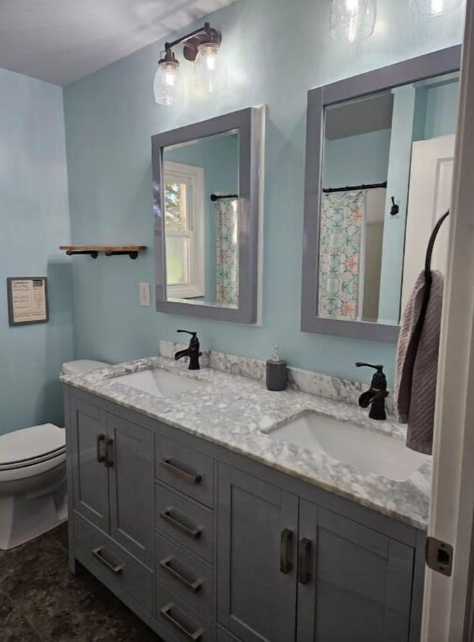 Recently remodeled bathroom with double vanity and walk-in shower.