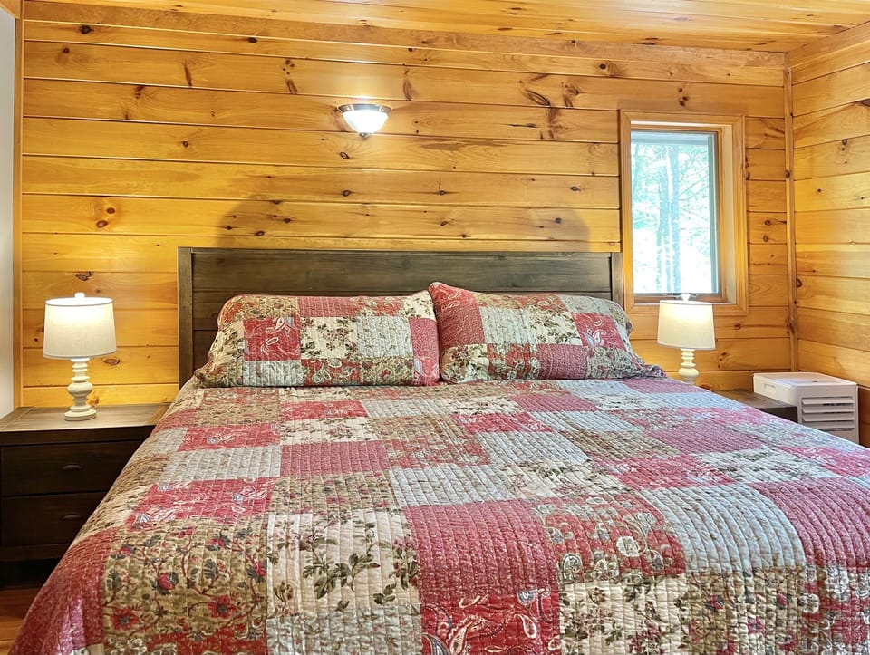 Luxuriate in style with a comfortable king bed, soft lighting, and a standing AC unit in bedroom 3 on the 2nd floor.
