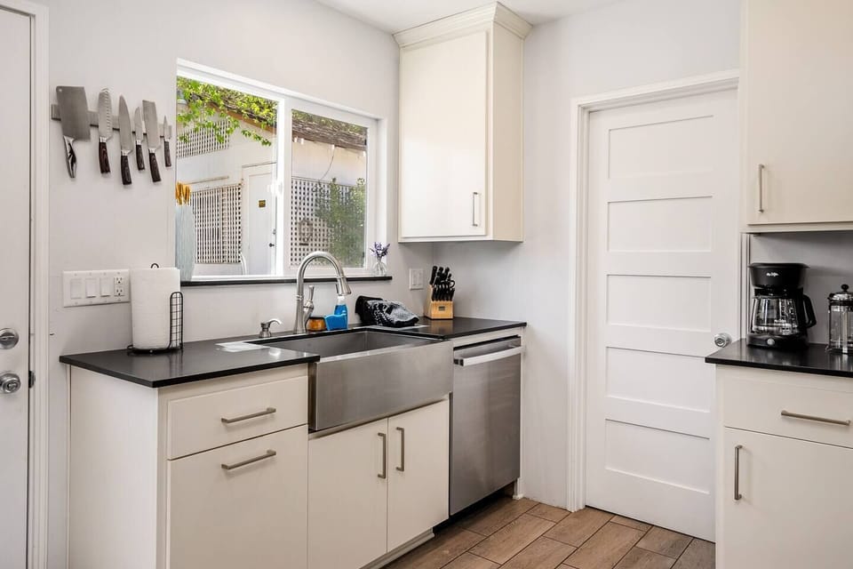 Stainless steel farmhouse sink and  up-scale kitchen appliances make this kitchen a dream to cook in. 
