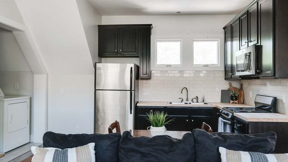 Stylish cabinetry and stainless appliances in a compact layout.