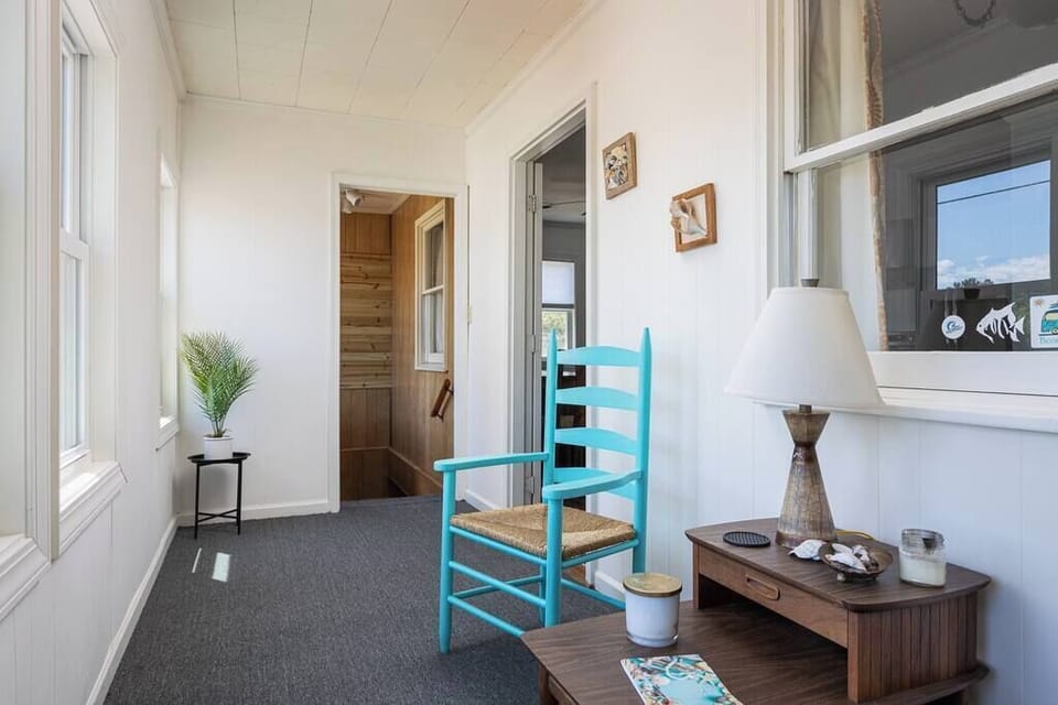 Top Level Sun Room with a Desk, Comfortable Seating, and the Perfect Space for Reading, Remote Work, or Relaxing.