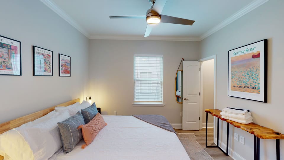 Bedroom 2- overhead fan, in suite bath, queen bed, art