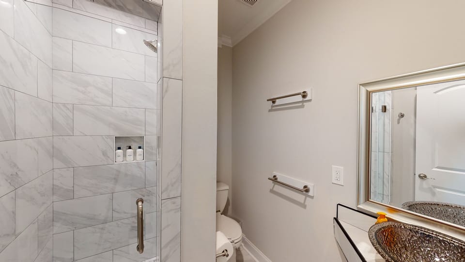 Bathroom 1- shower, glass door, shampoo, conditioner, body wash, tp, towels