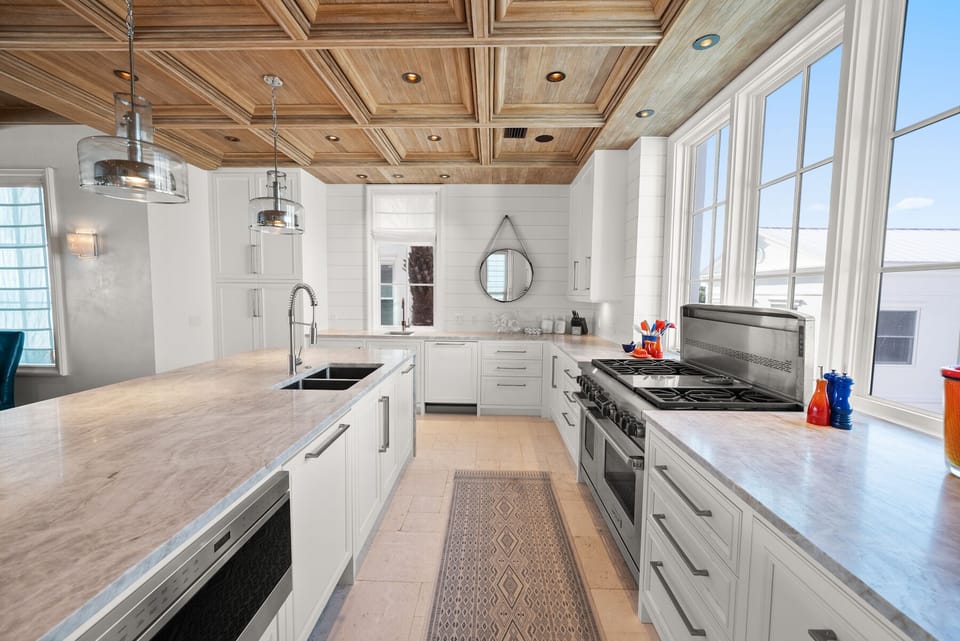 Craft culinary masterpieces in this stunning gourmet kitchen with marble countertops, professional-grade appliances, and soaring coffered ceilings.
