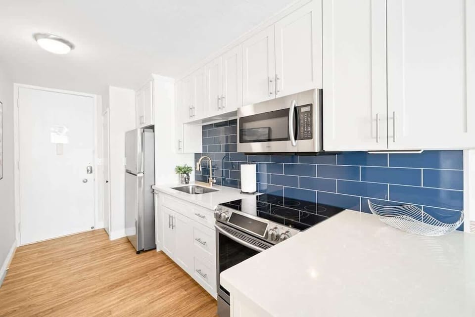Wooden kitchen featuring essential appliances and stocked wit some basics needed for cooking.