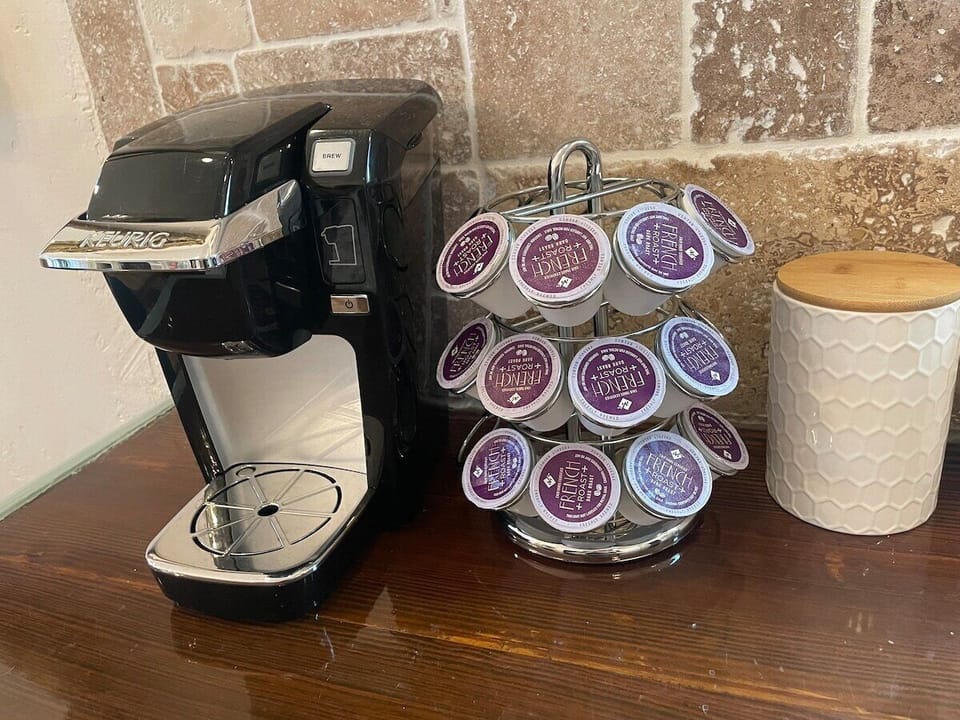 Keurig with fully stocked coffee, sugar & creamer. 