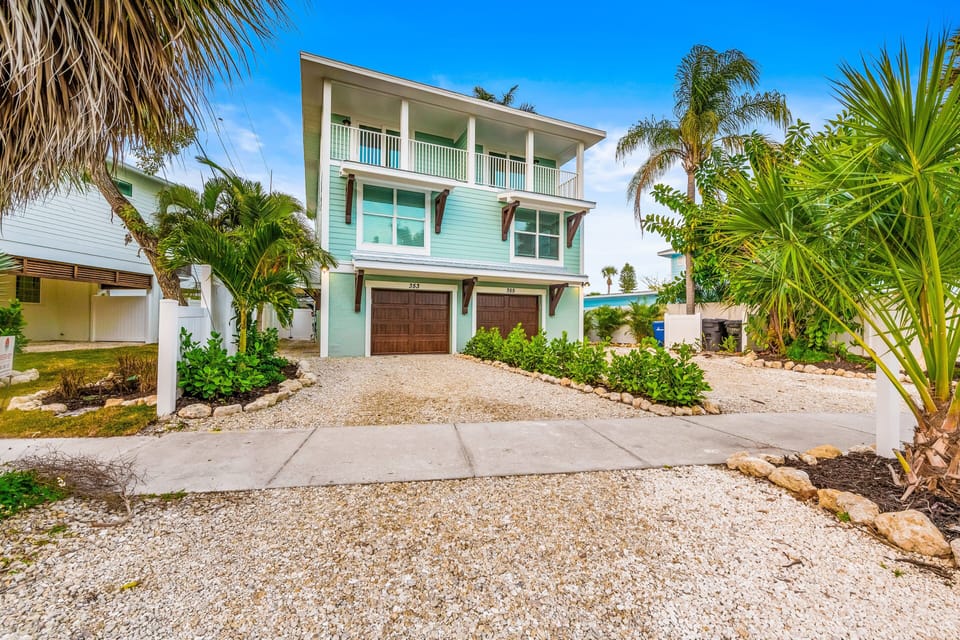 This beautifully designed island home combines coastal charm, generous outdoor living spaces, and a prime location near the beach.