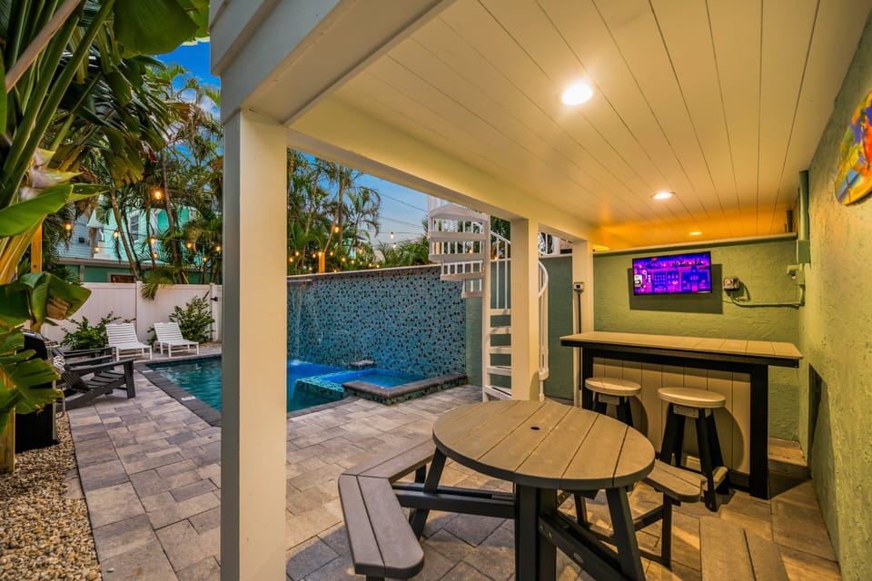 From morning coffee to evening cocktails, the covered outdoor entertainment space keeps everyone together.