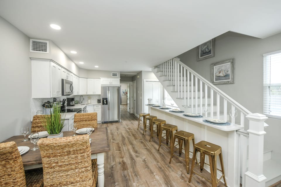 This well-equipped kitchen flows easily into a cozy dining nook, perfect for a quick meal between beach trips.