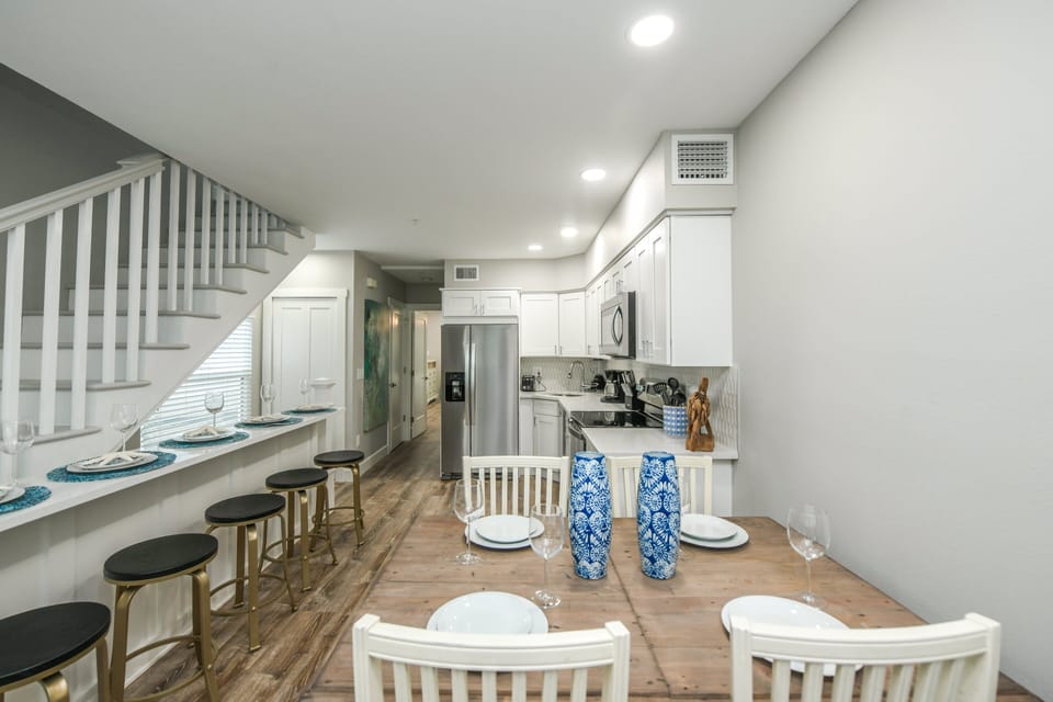 The dining area flows effortlessly into the living room, creating a comfortable space for meals, games, and conversation.