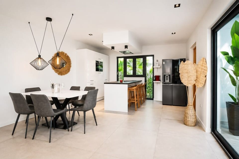 Fully equipped kitchen featuring modern appliances, cookware, essentials, and ample space for meal preparation.