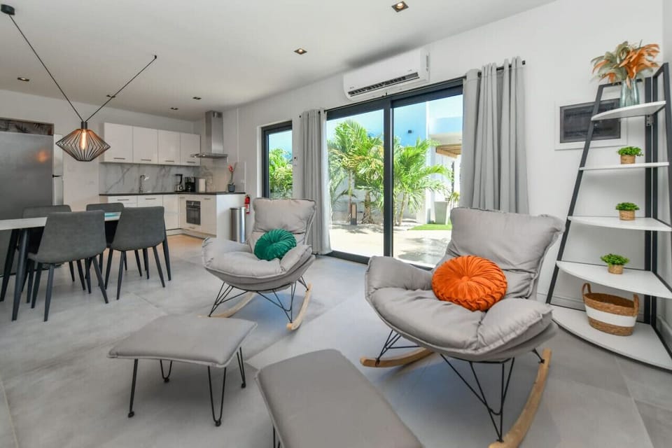 Apt Living Room | Step into the inviting living room of our spacious apartment, a perfect blend of comfort and style. Sink into the plush sofas, bask in the natural light streaming through the windows, and admire the tasteful decor.