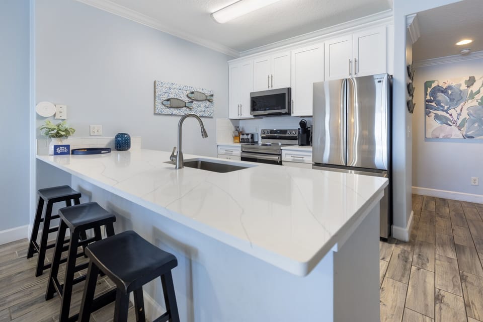Create culinary memories in your spacious kitchen featuring gleaming countertops, stainless steel appliances, and a perfect breakfast bar for morning coffee.