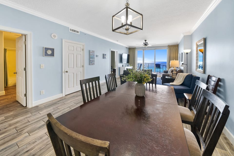 Gather around this spacious dining table where your group can share meals while enjoying stunning ocean views through floor-to-ceiling windows.