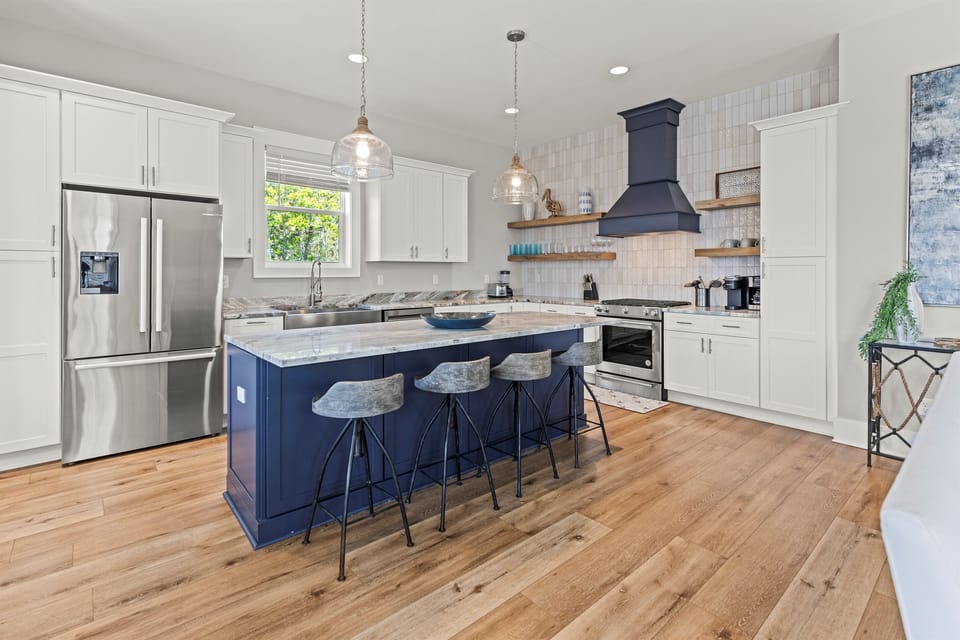 Cook in your gourmet kitchen with marble countertops, stainless steel appliances, and a spacious island for gathering.