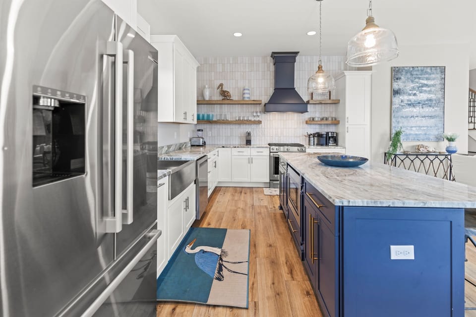 Cook with ease in your gourmet kitchen featuring marble countertops, stainless steel appliances, and a spacious island perfect for meal prep.
