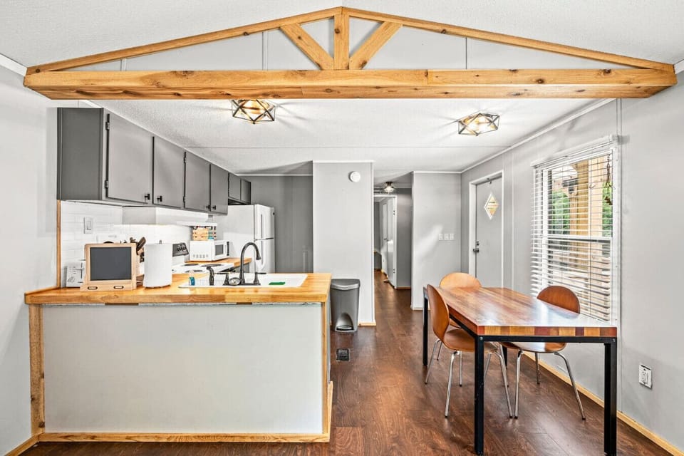 The kitchen area of the cottage. Includes a dining table with seating for four.
