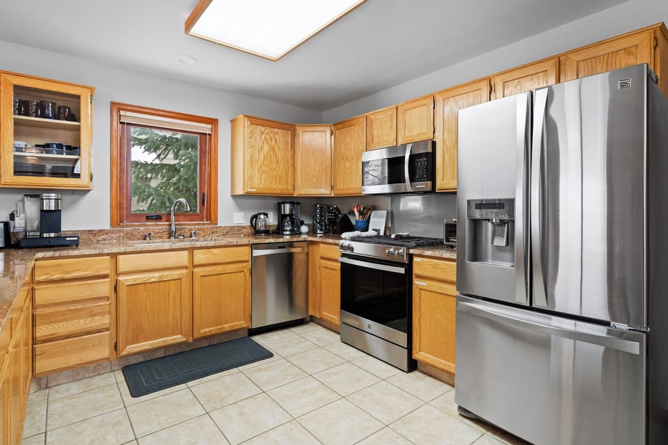 Cook your favorite meals in this fully-equipped kitchen featuring stainless steel appliances, granite countertops, and plenty of cabinet space for all your culinary needs.