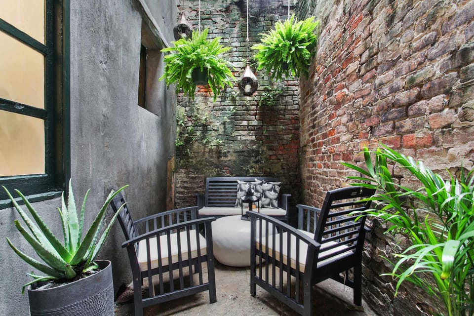 Private Courtyard | Exposed Brick Walls | Lush Greenery | First Floor