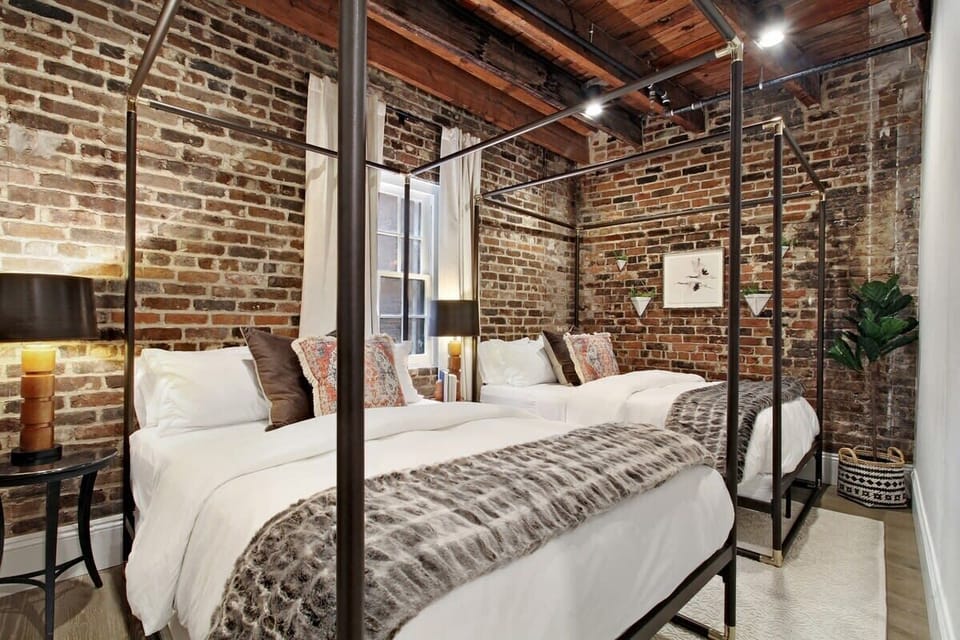 Bedroom 4 | 2 Queen Beds | Exposed Brick | Natural Light | Third Floor