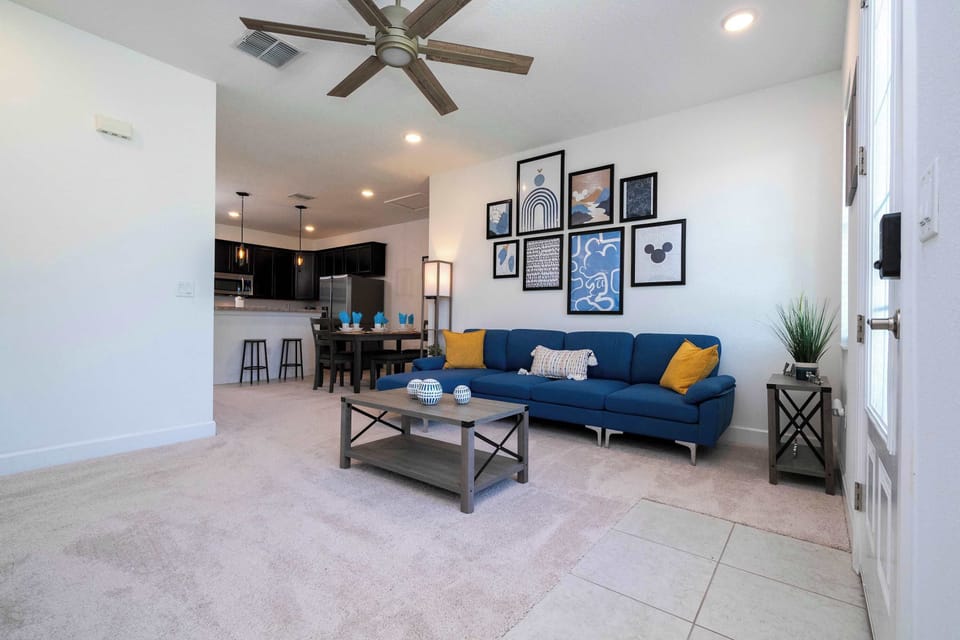 Open-concept layout flows to the modern kitchen with bar seating and a dining table-perfect for gathering over meals and games.