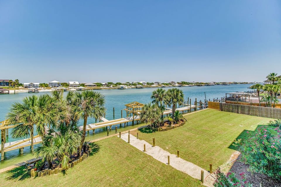 Wind Drift Orange Beach grounds with green space and Old River waterfront access