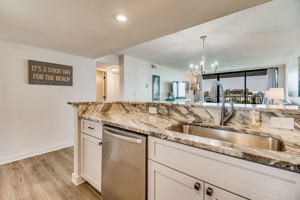 Kitchen with granite counters and complete essentials at Wind Drift Orange Beach bayside rental