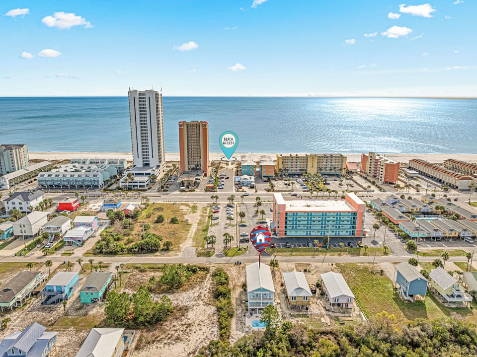 Aerial view of the full property in Gulf Shores, located directly across from Bahama Bob’s with easy public beach access just steps away. A prime spot for beach days, walkable dining, and coastal convenience.