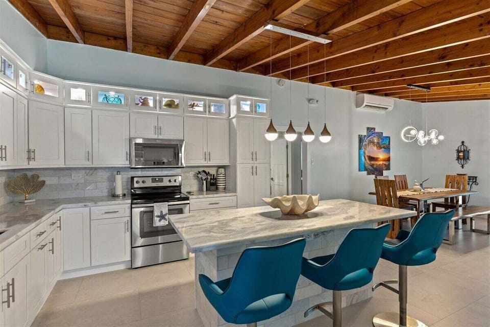 Share fresh catches and vacation memories around this spacious dining table for six.