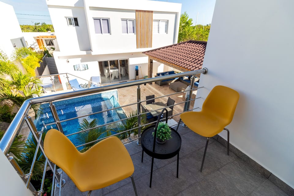 The bedroom offers direct access to a balcony with a view of the surroundings
