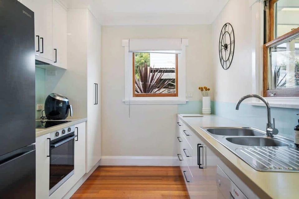 Modern kitchen with all the modern appliances including coffee machine, ice maker, dishwasher.