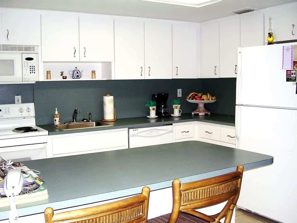 The well-equipped kitchen is open and connected to the living and dining area.