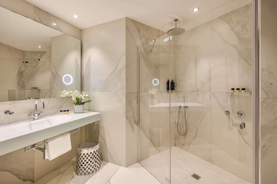 Shower, rainfall showerhead, slippers, towels