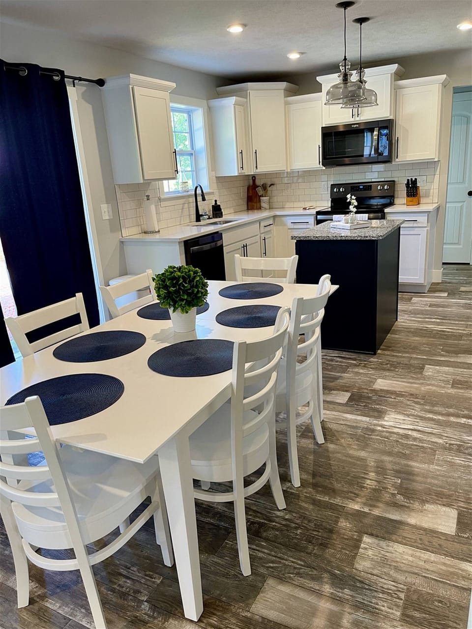Modern Kitchen and dining area, a spacious table for six, updated appliances, and plenty of natural light.