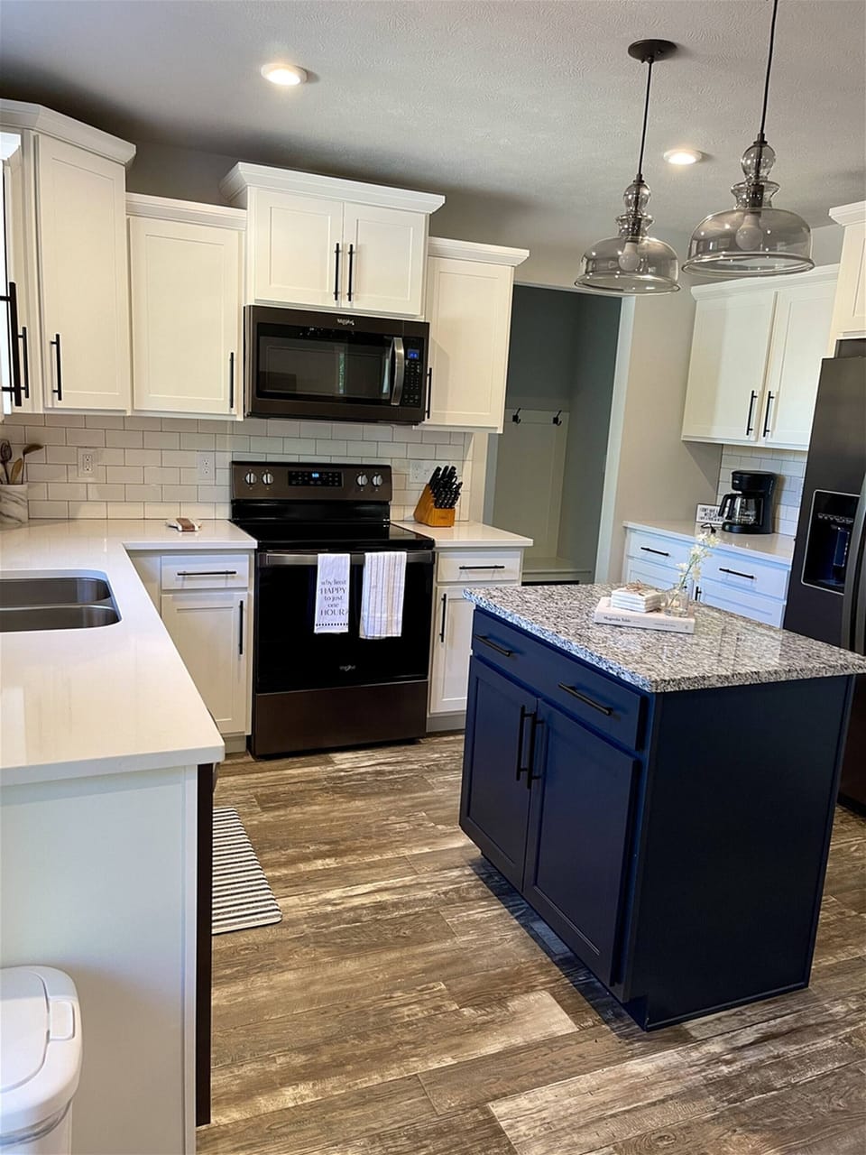 Stylish kitchen, modern appliances, a center island with granite countertop, and plenty of counter space.