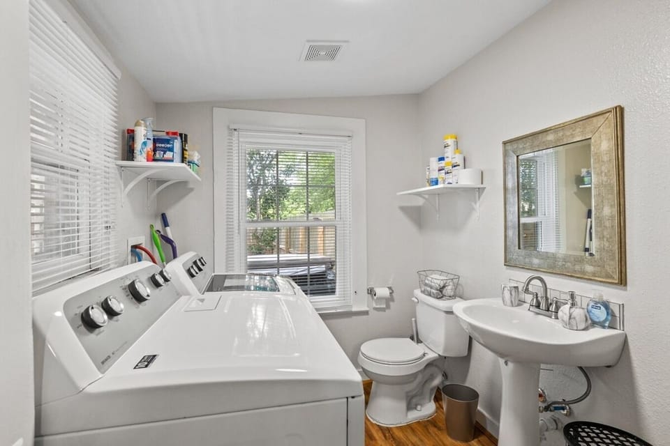Full size washer/dryer and 1/2 bath in this laundry room space.