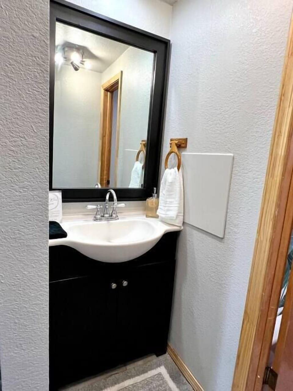 Bathroom sink is outside bathroom that has the tub/shower and toilet. 