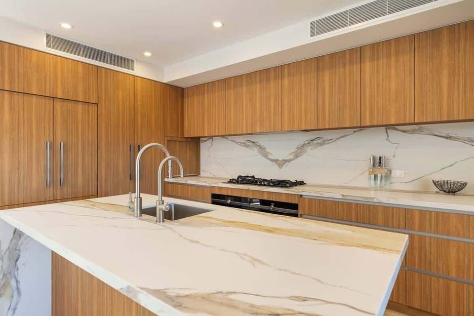 The stunning gourmet kitchen features an oversized marble island, premium appliances and is fully-equipped for your holiday catering.