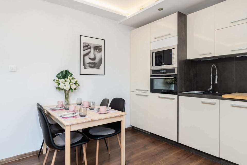 The sleek design of the kitchenette blending seamlessly with the living area.