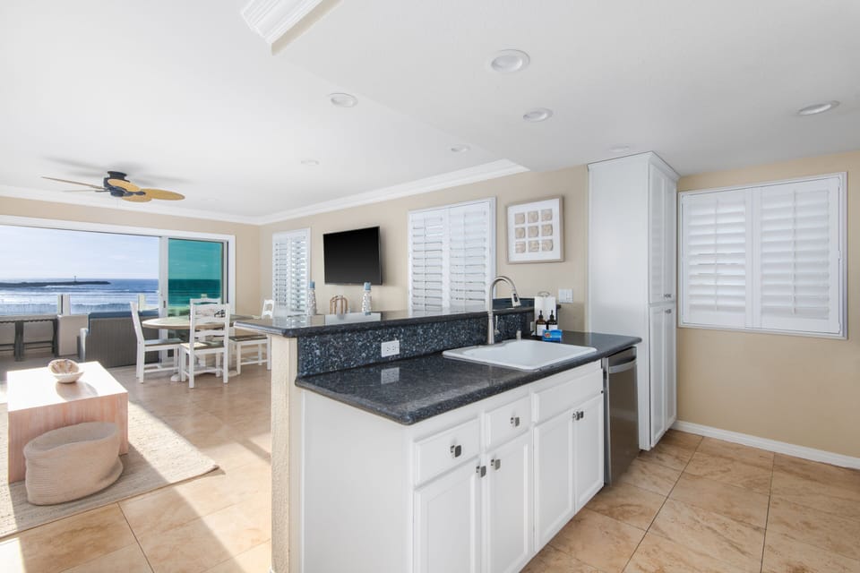 This open-plan living space seamlessly integrates a fully equipped kitchen, ensuring a relaxing stay.