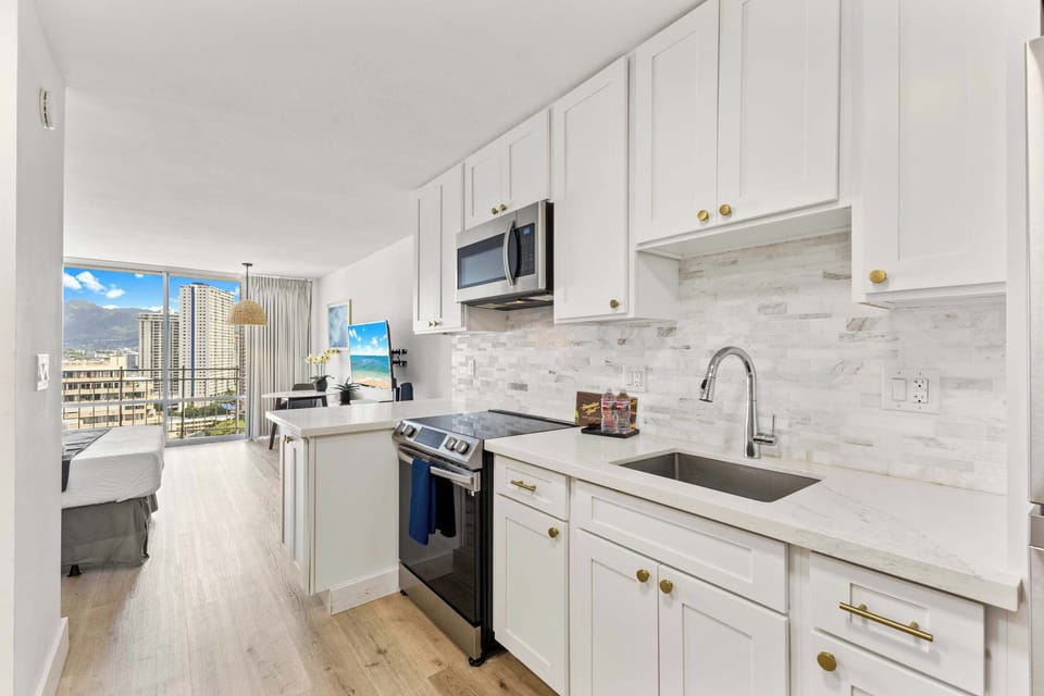 A cozy wooden kitchen featuring essential appliances and stocked wit some basics needed for cooking.