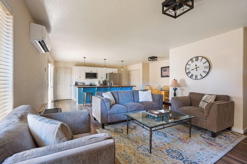Relax in your spacious living room with plush seating, elegant glass coffee table, and open kitchen perfect for entertaining.