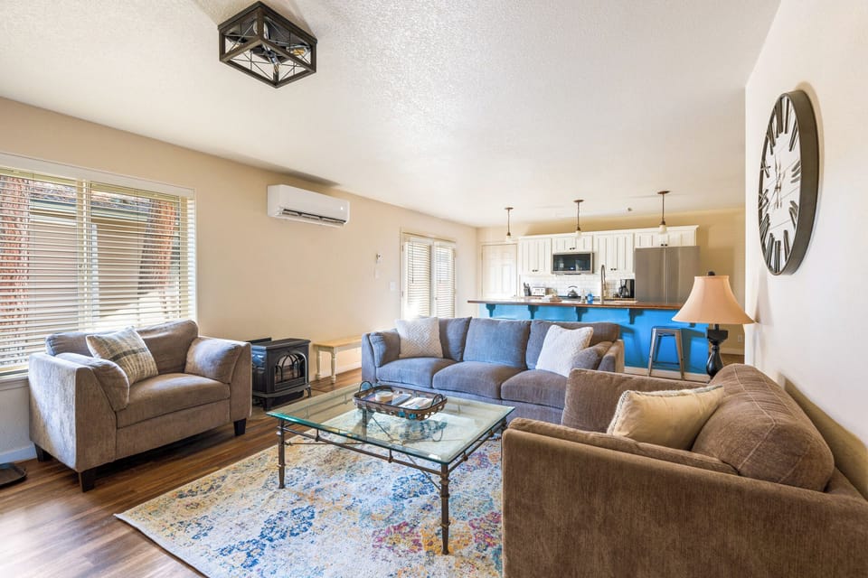 Sink into plush sofas and unwind in your spacious living room, where natural light streams through blinds and modern comfort meets home.