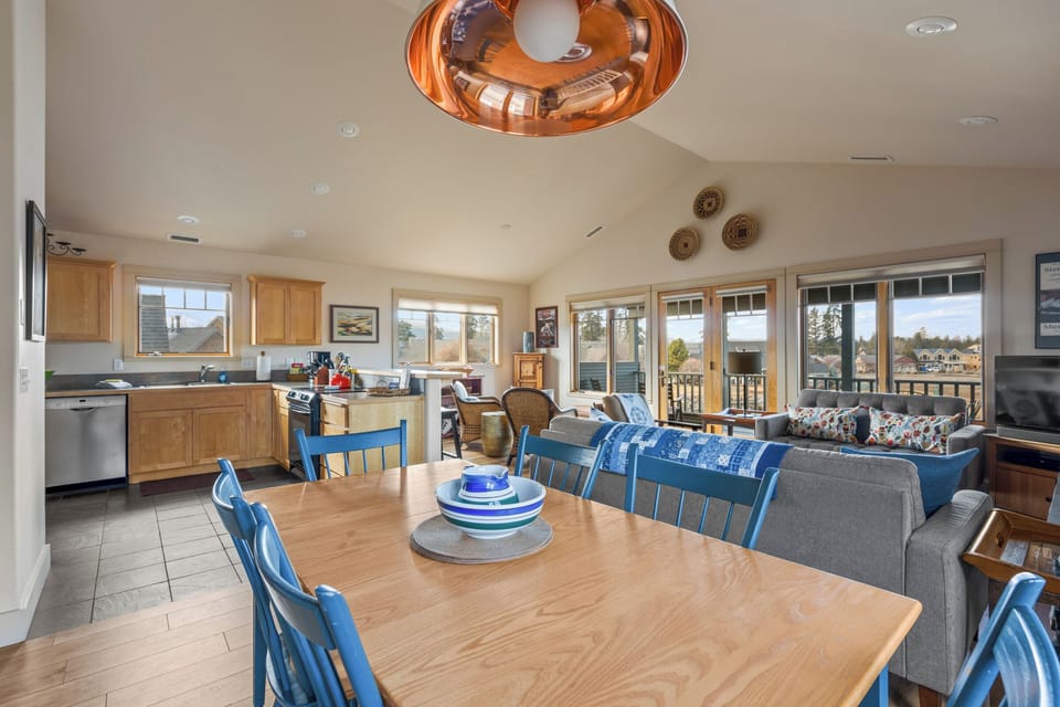 Gather around your spacious dining table for memorable meals while soaking in scenic views through expansive windows.