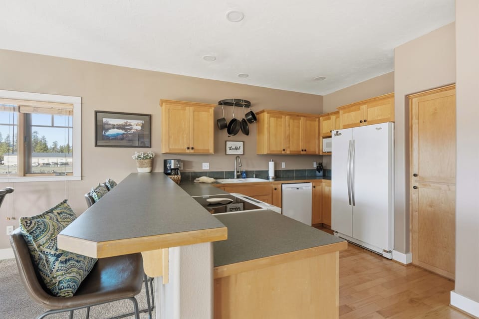 Gather around this spacious kitchen island where you'll prepare meals with modern appliances and ample counter space for your culinary adventures.